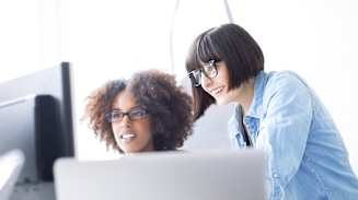 Young woman helping a female trainee