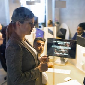 man and woman talking in office conference room