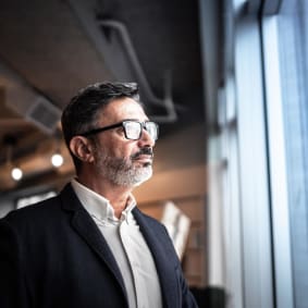 Business Man Looking Out of Window