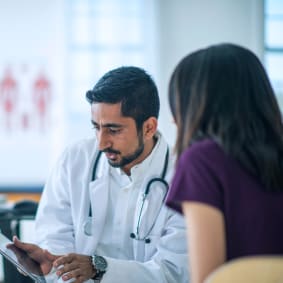 medical professional reviewing information on a tablet
